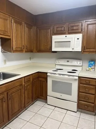 a kitchen with stainless steel appliances granite countertop a sink and a stove