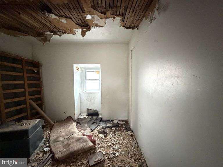 3923 Ridgewood Avenue Baltimore, MD 21215 - Photo 13 of 18 a bedroom with bed and a window