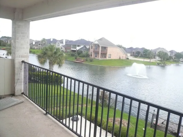 a view of a livingroom with wooden floor and a large window