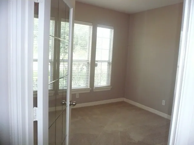 a room with a desk and windows