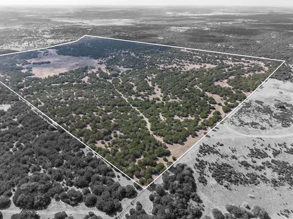 a view of a lake with beach and city view
