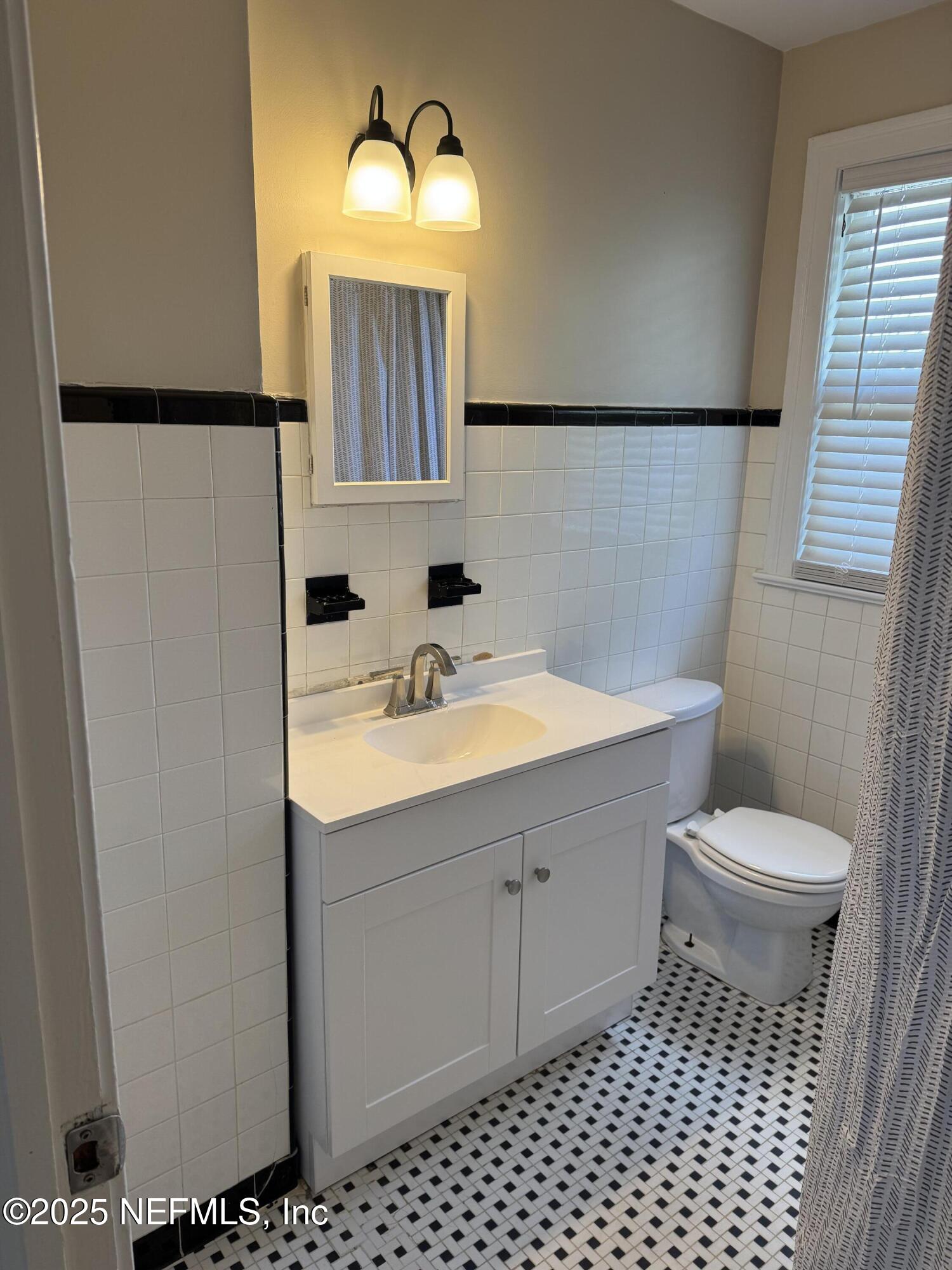 300 Bay Street Neptune Beach, FL 32266 - Photo 11 of 12 a bathroom with a sink toilet and shower