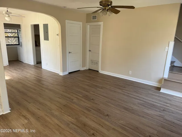 a view of a room with wooden floor