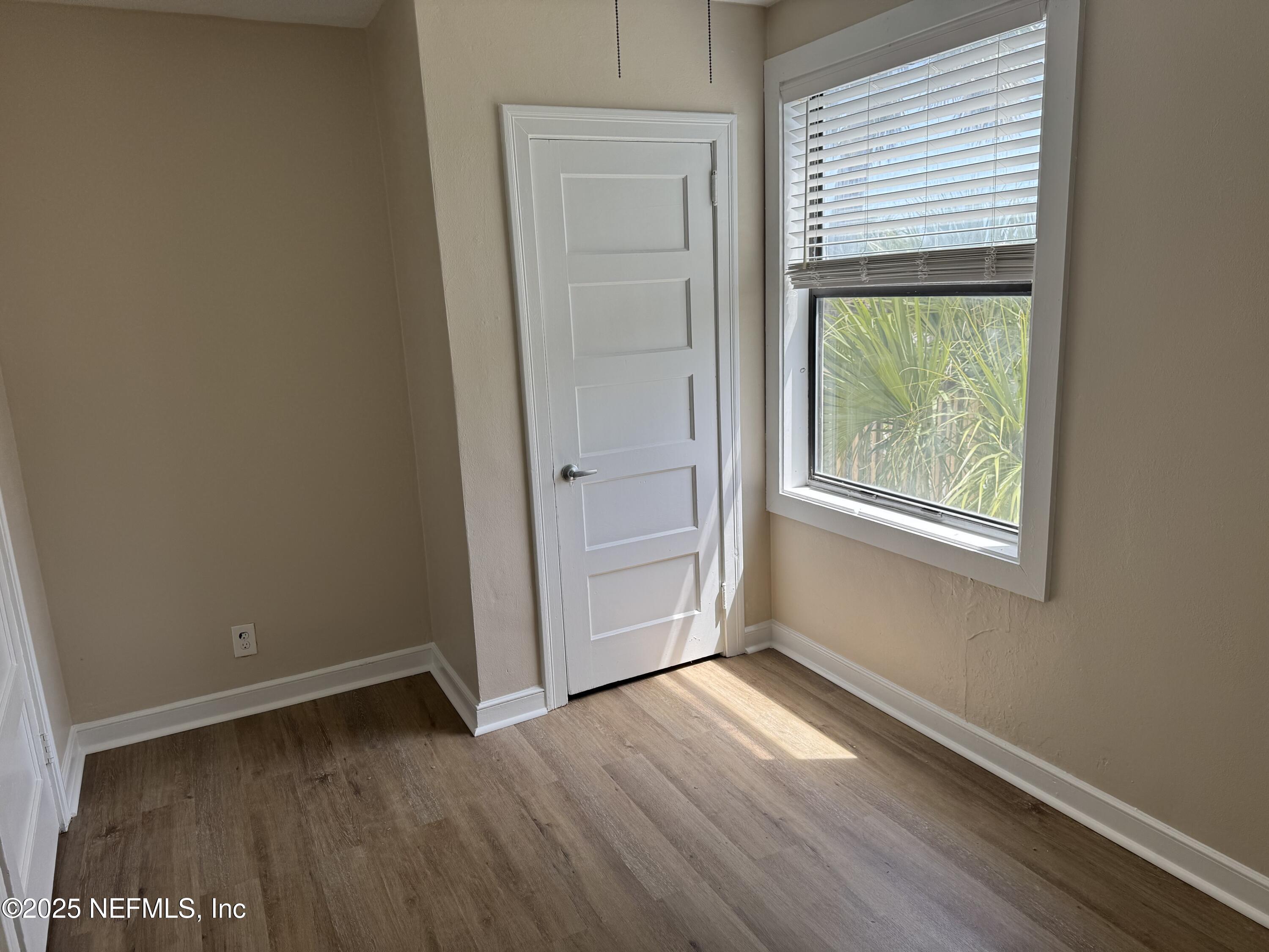 300 Bay Street Neptune Beach, FL 32266 - Photo 9 of 12 an empty room with wooden floor and windows