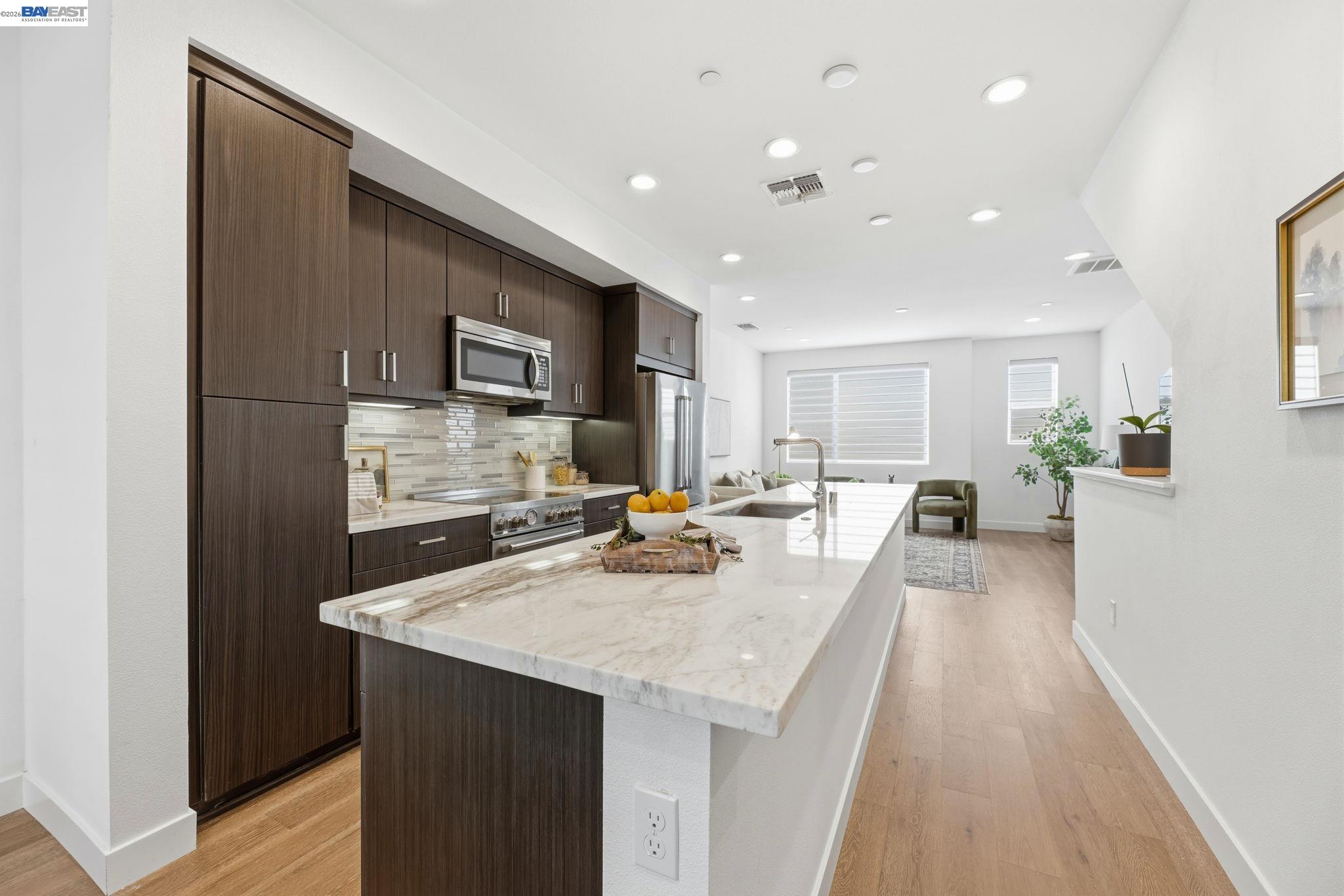 931 Edy Lane Oakland, CA 94607 - Photo 12 of 41 a kitchen with counter top space a sink appliances and cabinets