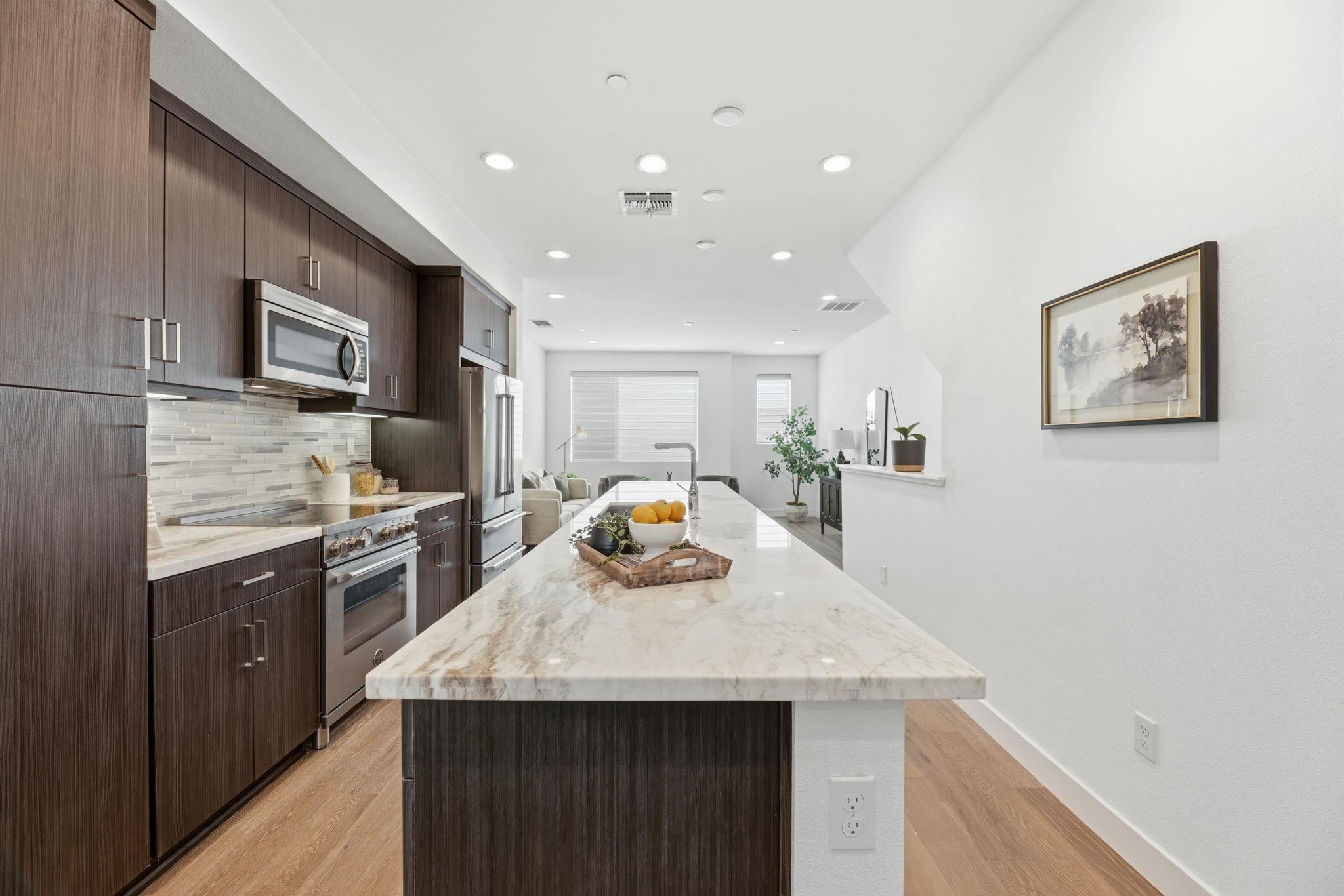 931 Edy Lane Oakland, CA 94607 - Photo 14 of 41 a kitchen with a sink a kitchen island and stainless steel appliances