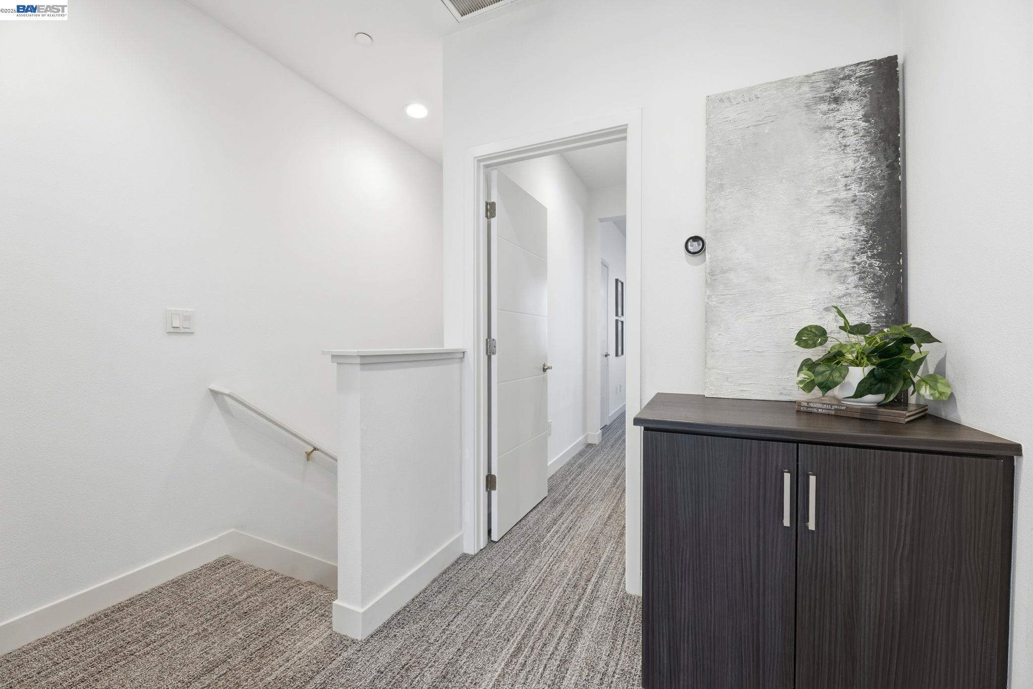 931 Edy Lane Oakland, CA 94607 - Photo 23 of 41 a hallway with wooden floor and staircase