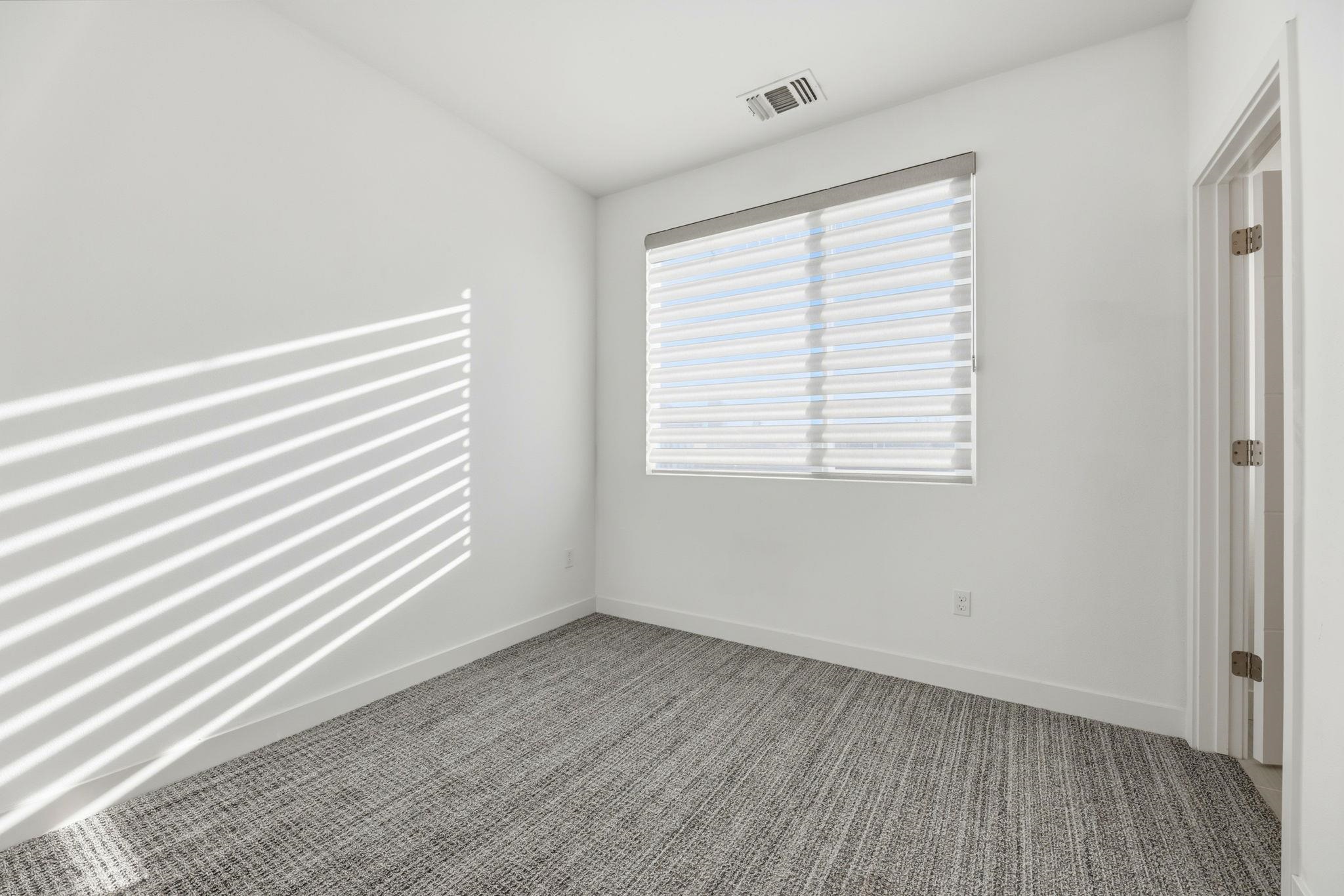 931 Edy Lane Oakland, CA 94607 - Photo 24 of 41 an empty room with wooden floor and windows