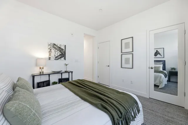 a bedroom with a bed and a table