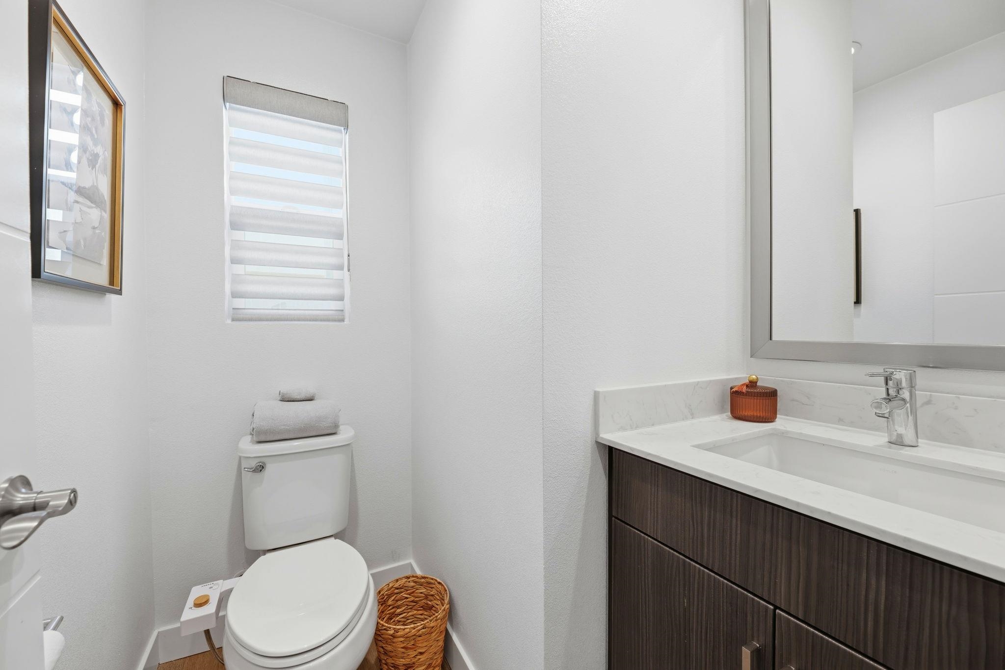 931 Edy Lane Oakland, CA 94607 - Photo 30 of 41 a bathroom with a toilet a sink a vanity and mirror