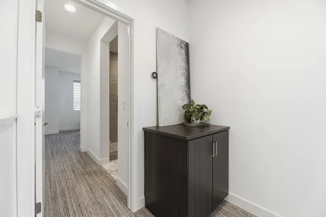 a view of a hallway with wooden floor