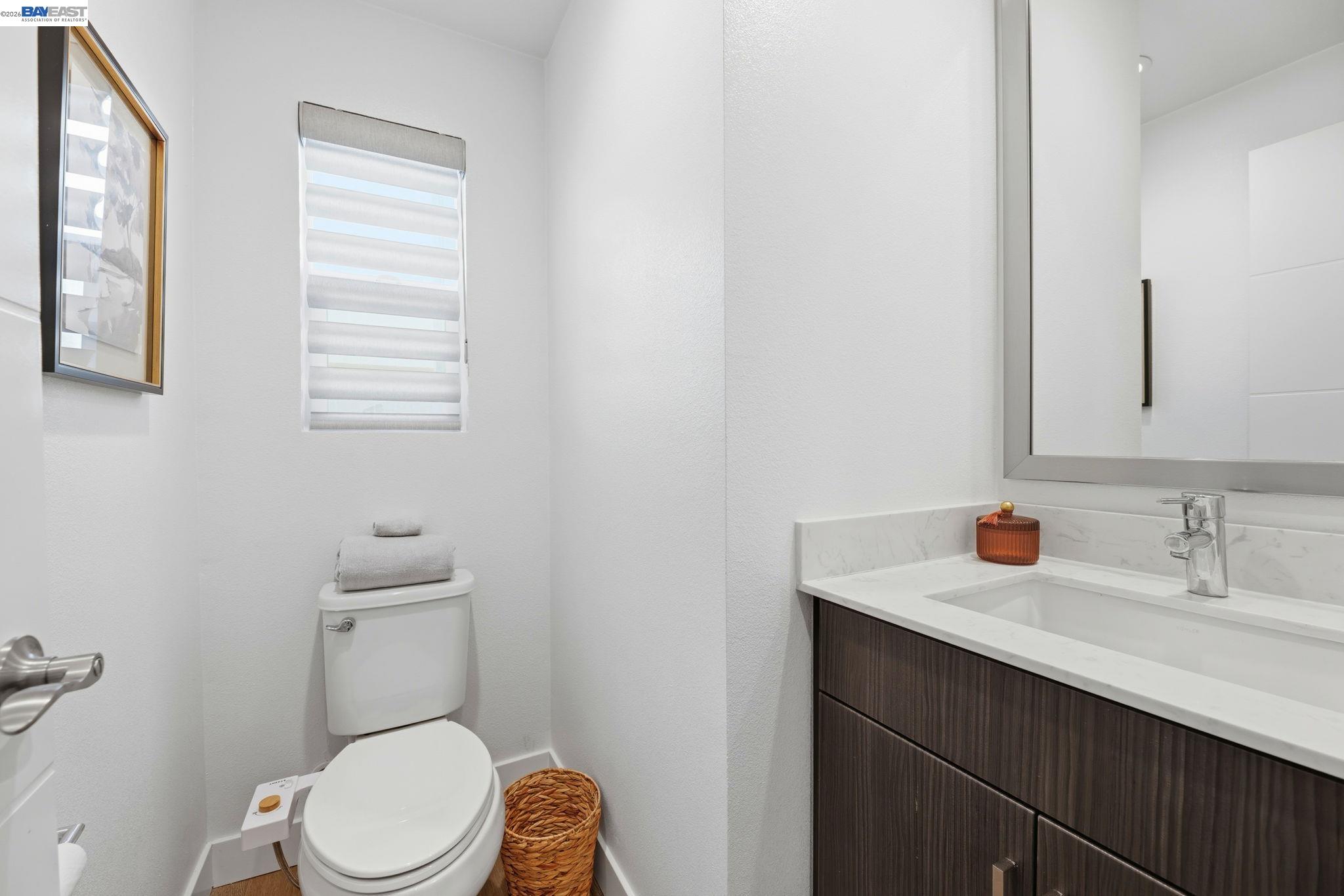 931 Edy Lane Oakland, CA 94607 - Photo 33 of 41 a bathroom with a toilet a sink a vanity and mirror