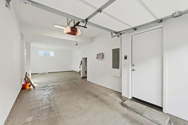 an empty room with a ceiling fan and carpet