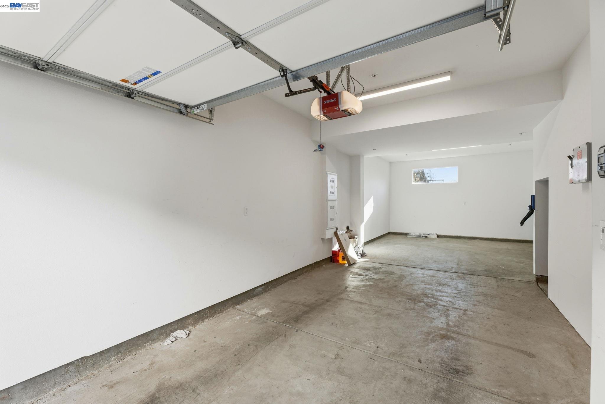 931 Edy Lane Oakland, CA 94607 - Photo 38 of 41 an empty room with a ceiling fan and carpet