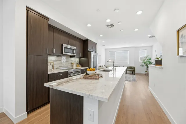 a kitchen with counter top space a sink appliances and cabinets