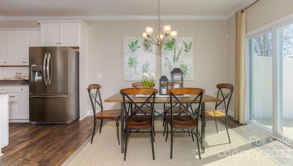 206 Creekview Road Hendersonville, NC 28792 - Photo 8 of 36 a dining room with furniture a chandelier and wooden floor