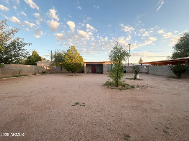 a brick building with a potted plant and a table