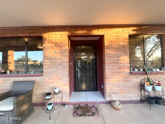 a view of a patio with table and chairs potted plants with wooden floor
