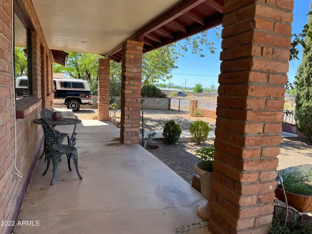 a living room with furniture and a book shelf