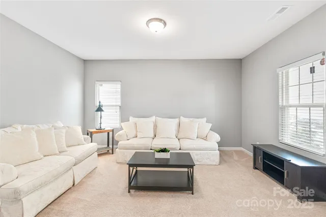 a living room with furniture a large window and a couch