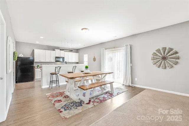 a living room with furniture and a kitchen view