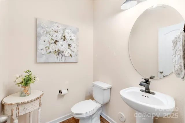 a bathroom with a toilet sink and a mirror