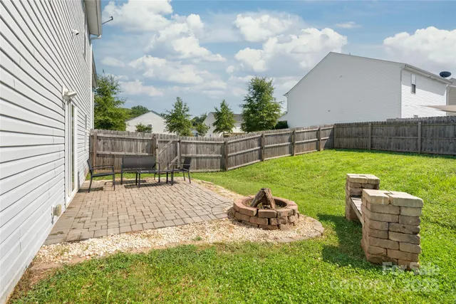 a view of a backyard with sitting area