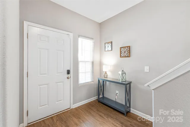 a view of a kitchen with wooden floor and window