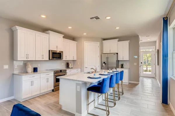 a kitchen with stainless steel appliances kitchen island granite countertop a sink and cabinets