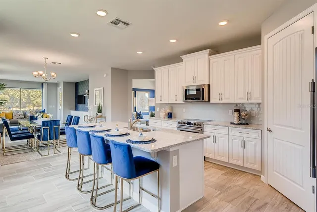 a kitchen with counter space appliances cabinets and furniture