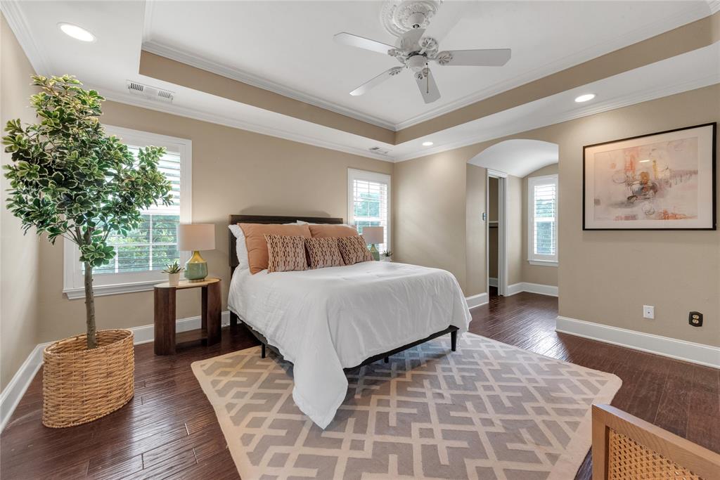 5102 Ridgedale Avenue Dallas, TX 75206 - Photo 15 of 27 Hardwood flooring throughout this room featuring a tray ceiling with a ceiling fan