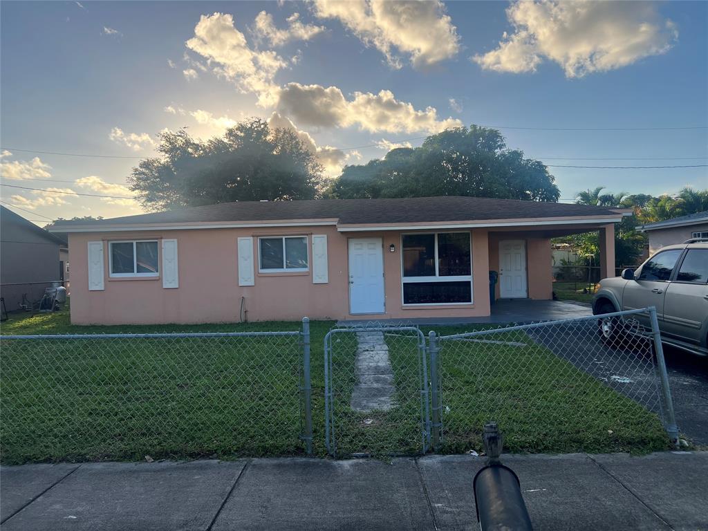 1451 Northwest 33rd Avenue Lauderhill, FL 33311 - Photo 1 of 13 a view of a house with backyard sitting area and garden