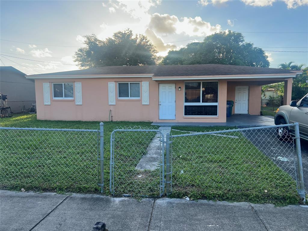 1451 Northwest 33rd Avenue Lauderhill, FL 33311 - Photo 2 of 13 a front view of a house with garden