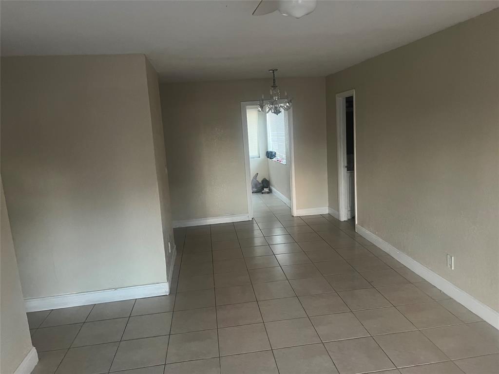 1451 Northwest 33rd Avenue Lauderhill, FL 33311 - Photo 7 of 13 wooden floor in an empty room and a window