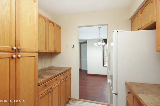 a kitchen with a refrigerator and cabinets