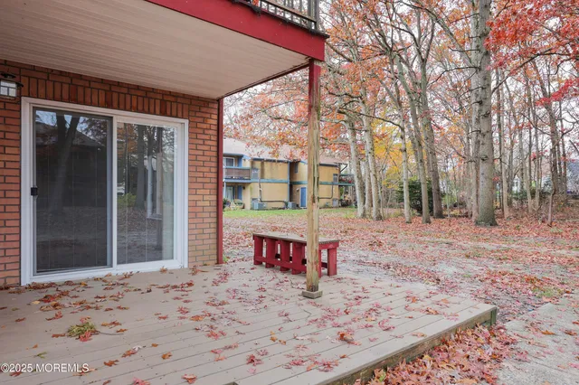 a view of a porch with a table and chairs