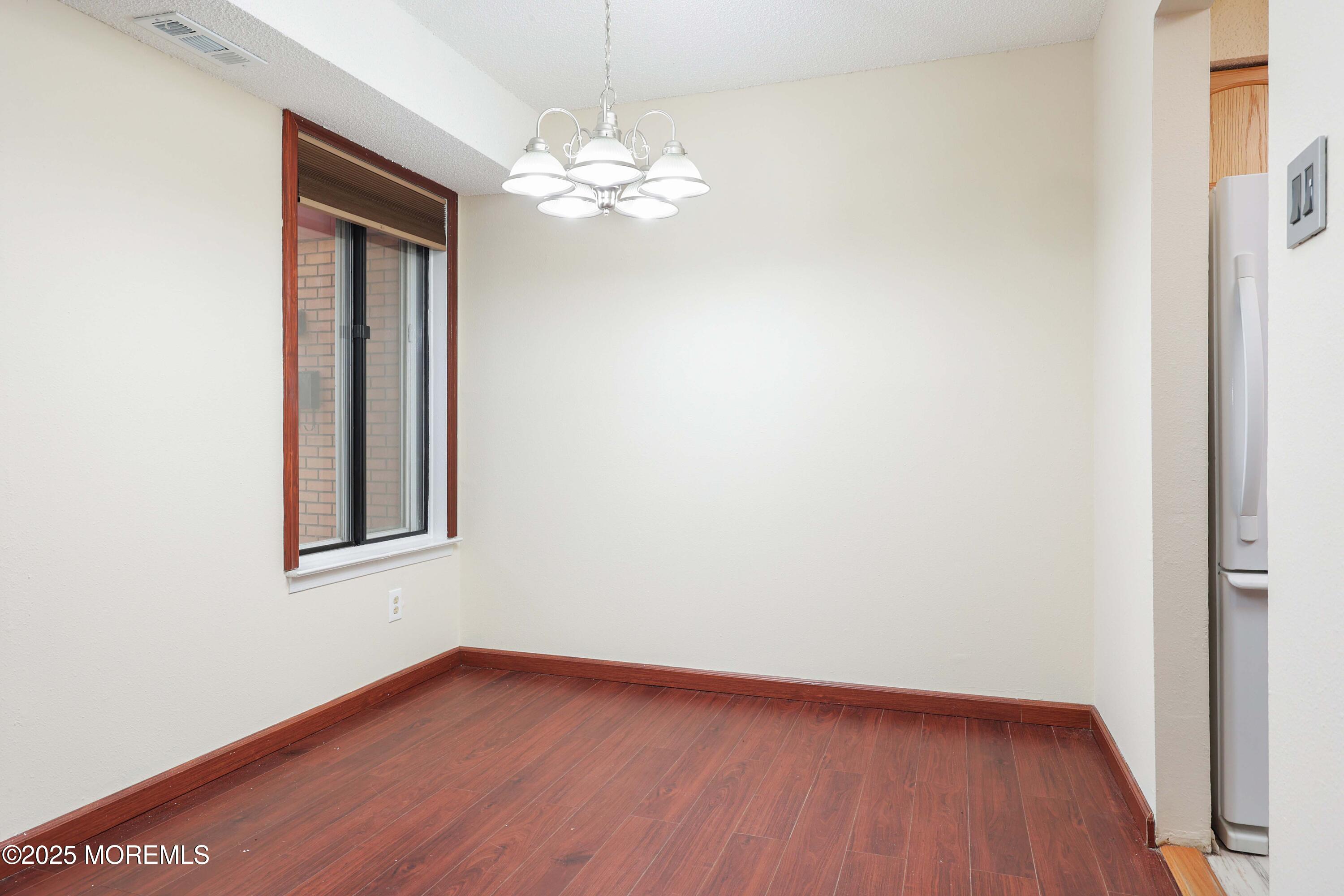 89 Northrup Drive, Unit 75 Brick, NJ 08724 - Photo 8 of 22 a view of an empty room with wooden floor
