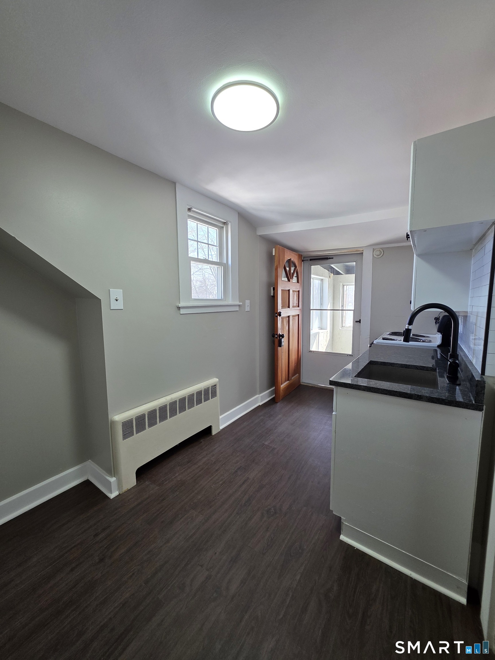 396 West Main Street, Unit 3 New Britain, CT 06052 - Photo 2 of 17 a view of a room with wooden floor and lots of cabinet