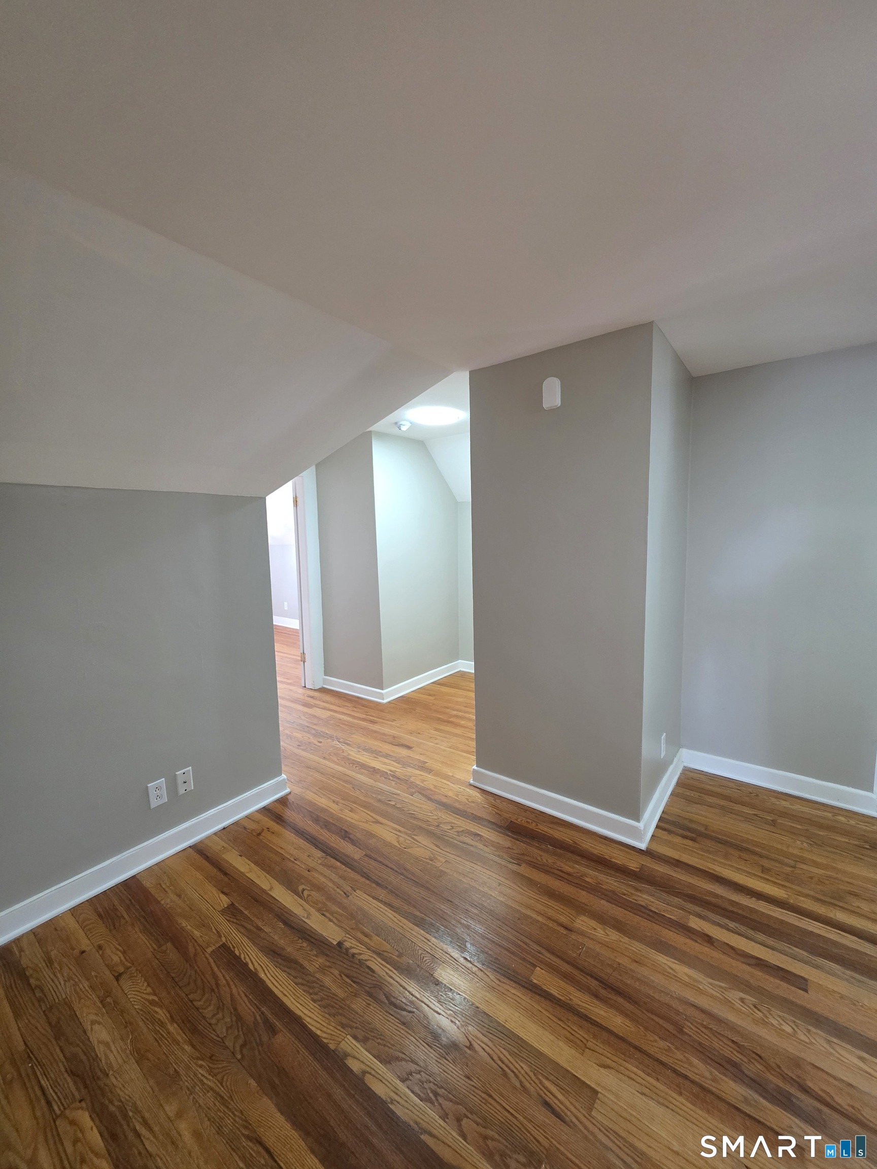 396 West Main Street, Unit 3 New Britain, CT 06052 - Photo 8 of 17 a view of an empty room with wooden floor