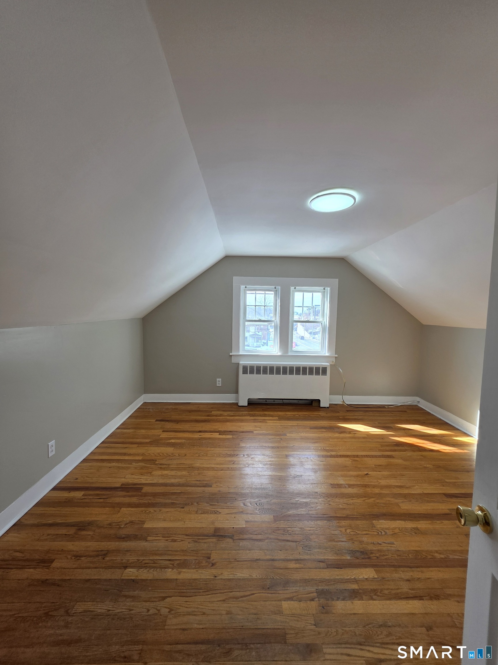 396 West Main Street, Unit 3 New Britain, CT 06052 - Photo 9 of 17 a view of empty room with window and wooden floor