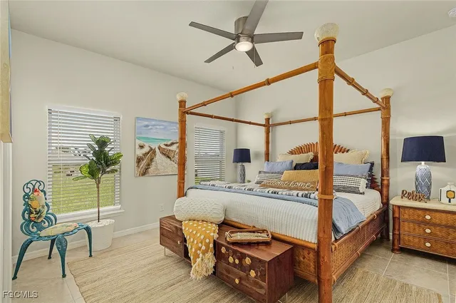 a bedroom with a bed a couch and a potted plant