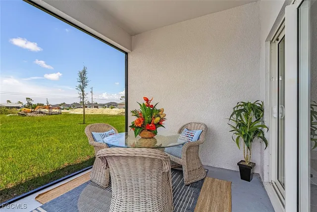 a view of a porch with furniture and garden