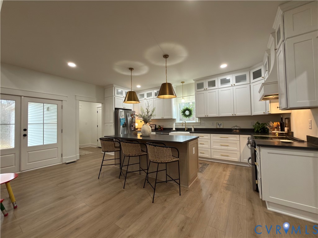 7017 Claiborne Road Sutherland, VA 23885 - Photo 26 of 62 a kitchen with a sink cabinets and wooden floor