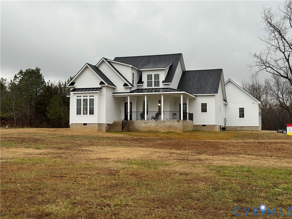 7017 Claiborne Road Sutherland, VA 23885 - Photo 4 of 62 a front view of a house with a garden