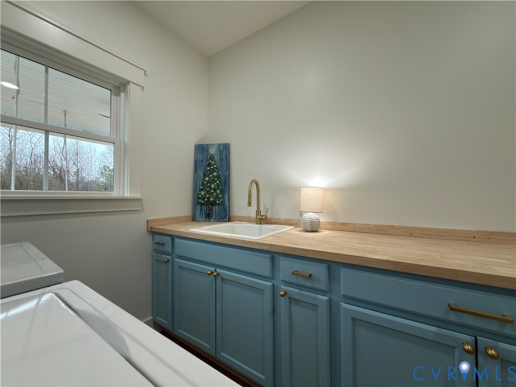 7017 Claiborne Road Sutherland, VA 23885 - Photo 48 of 62 a utility room with a sink dryer and washer
