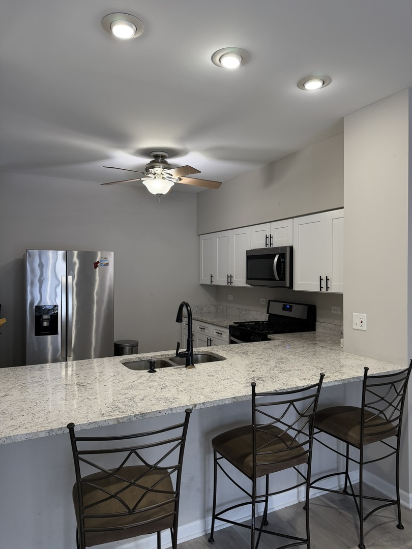 2522 Arcadia Circle Naperville, IL 60540 - Photo 3 of 18 a kitchen with a dining table and chairs