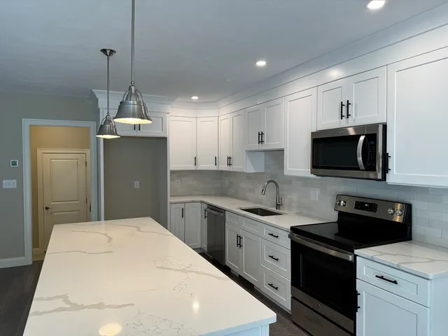 a kitchen with a sink a stove and refrigerator