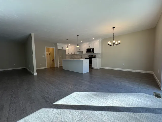 a view of a kitchen with a sink and dishwasher cabinet with wooden floor