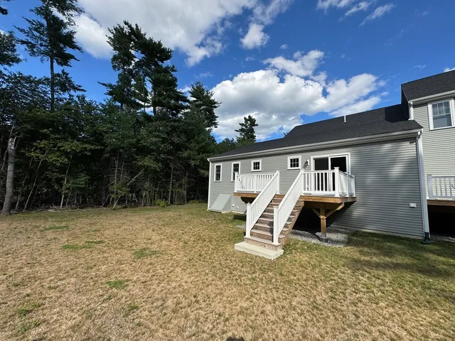 a view of a house with a yard and sitting area