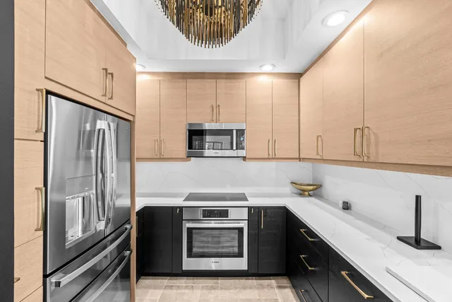 a view of a refrigerator in kitchen and wooden floor